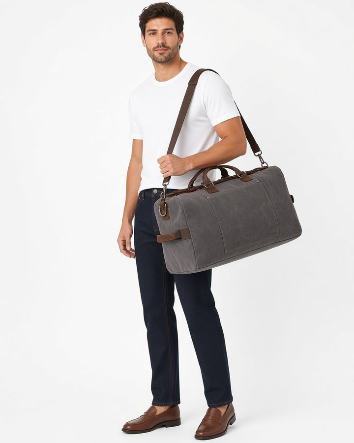 Hayes Waxed Canvas Weekender - worn by model walking, white studio
