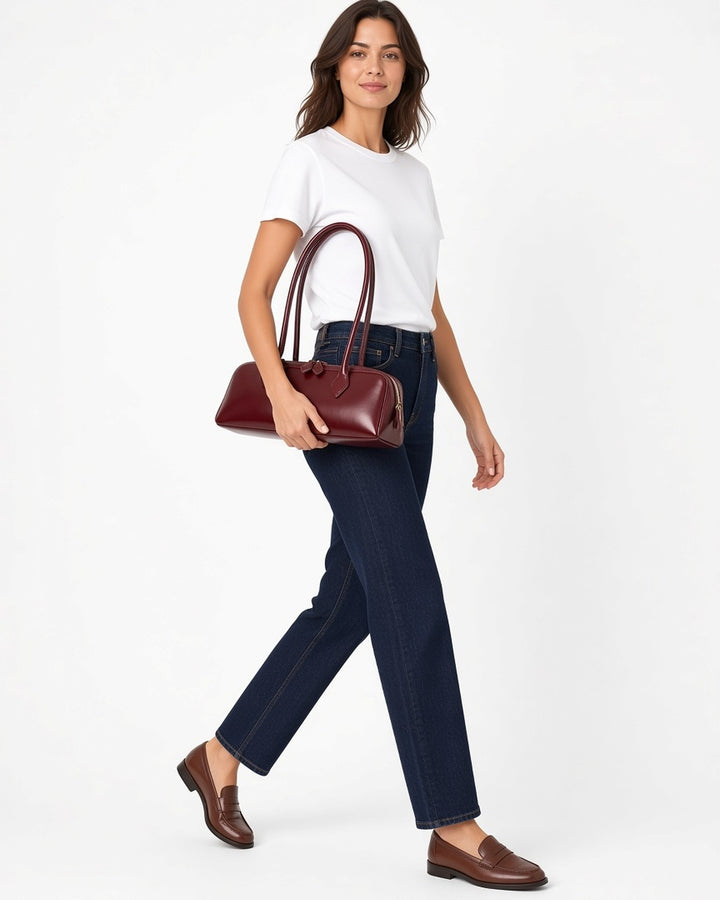 Éléanor French Baguette Leather Bag - worn by model walking, white studio