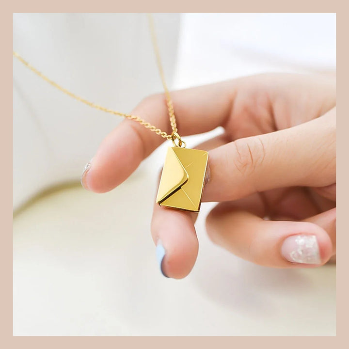 Elodie envelope pendant held in hand to show its size