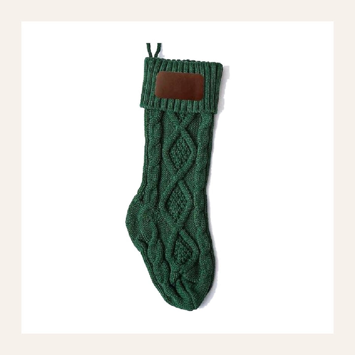 Noelle cable-knit stocking in green, folded cuff and blank faux-leather patch