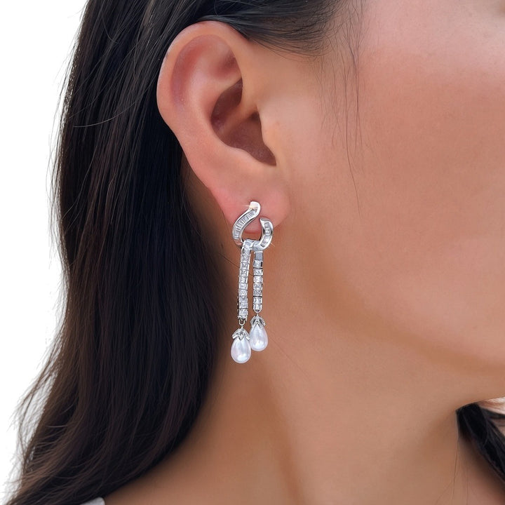 Seraphina pearl drop earring worn on the ear, front three-quarter view (illustration)