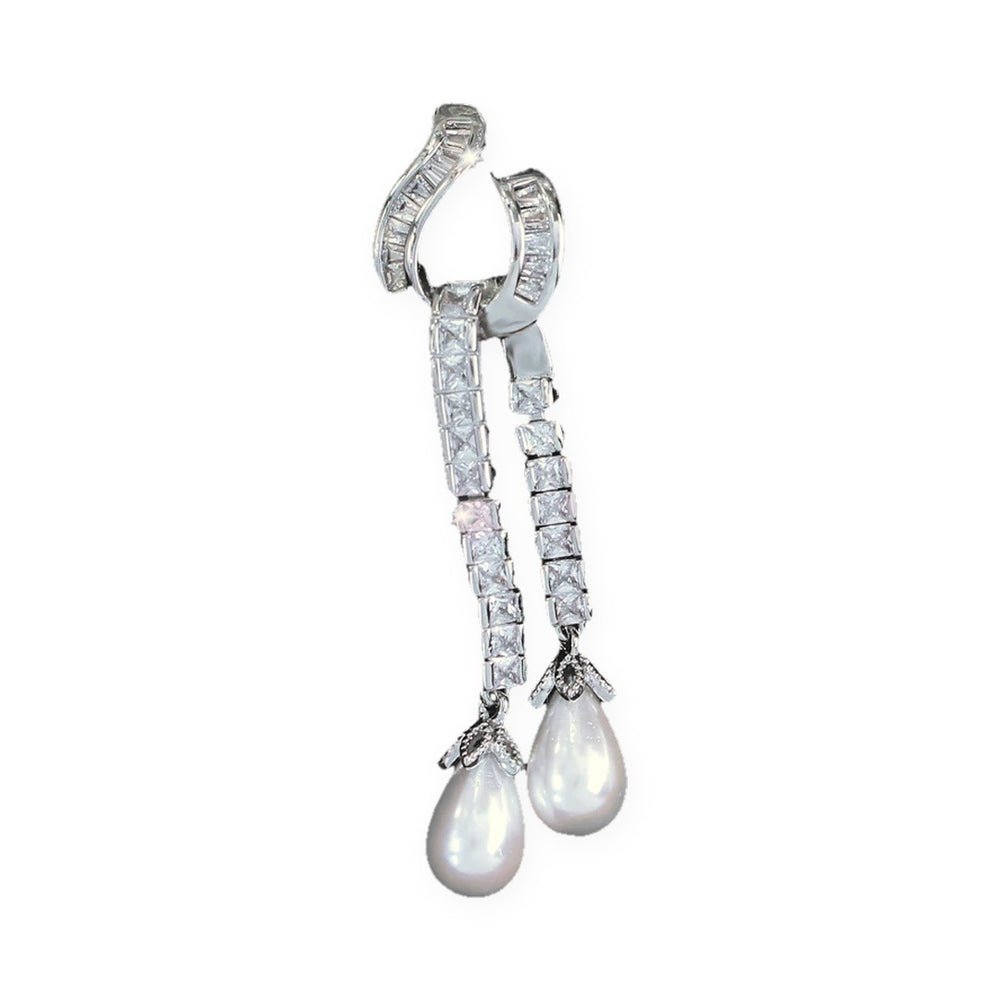 Single Seraphina earring showing the curved zirconia hook and two strands ending in faux pearl drops