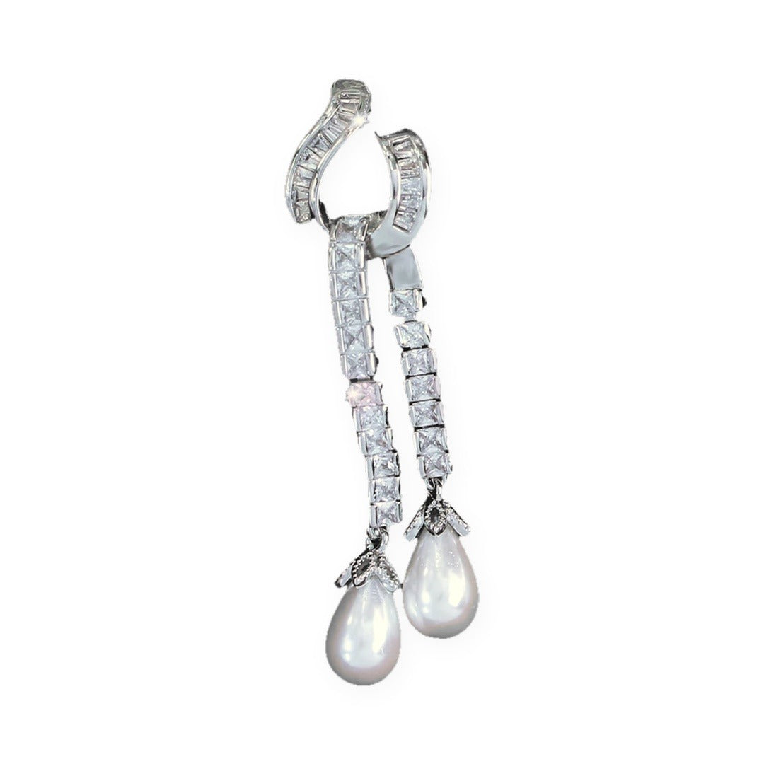 Single Seraphina earring showing the curved zirconia hook and two strands ending in faux pearl drops